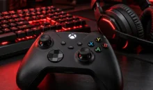 Mando de videojuegos con teclado y auriculares en un escritorio con iluminación roja